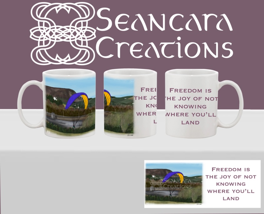 Paraglider - Freedom is the joy of not knowing where you'll land Printed mug with an artistic digital drawing of a paraglider with bright blue and orange sail in front of hilly scene & reservoir & quote